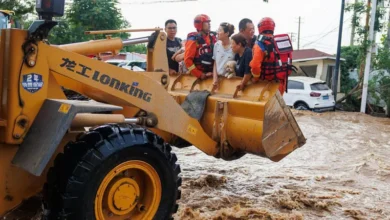 Floods in Beijing have submerged roads and left residents stranded