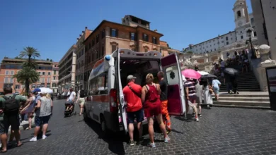 Paramedics provide aid to tourists and residents with an ambulance