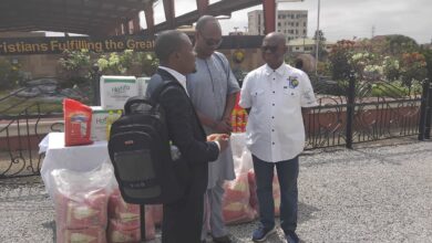 Ivan Heathcote Fumador, Coordinator for the Blind Union (left) showing appreciation to CCC Pastor, Jacob Seth Dadson for the food items during the presentation