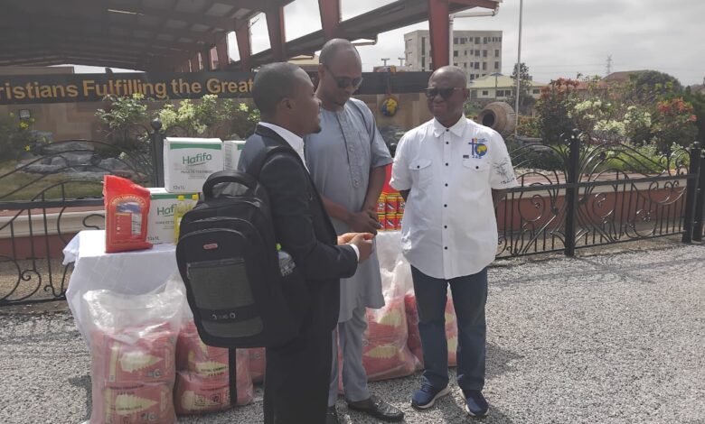 Ivan Heathcote Fumador, Coordinator for the Blind Union (left) showing appreciation to CCC Pastor, Jacob Seth Dadson for the food items during the presentation