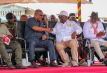 Joshua Ansah (3rd from right), Secretary-General, TUC, in a hearty handshake with President John Dramani Mahama at the May Day commemoration. Looking on are Julius Drebrah (left), Chief of Staff, and other dignitaries.