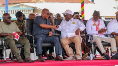 Joshua Ansah (3rd from right), Secretary-General, TUC, in a hearty handshake with President John Dramani Mahama at the May Day commemoration. Looking on are Julius Drebrah (left), Chief of Staff, and other dignitaries.