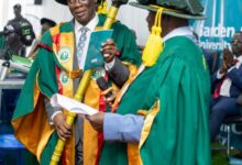 Prof Eric Kwasi Ofori holding his staff of office