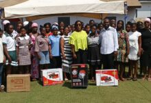 Honorable Laurrette Korkor Asante in green blouse in a group photo with the beneficiries