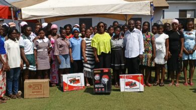 Honorable Laurrette Korkor Asante in green blouse in a group photo with the beneficiries