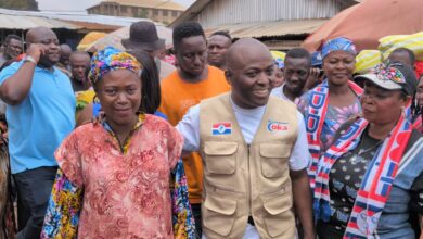 Chairman Odeneho Kwaku Appiah flanked by two traders at the Kumasi Race Course.